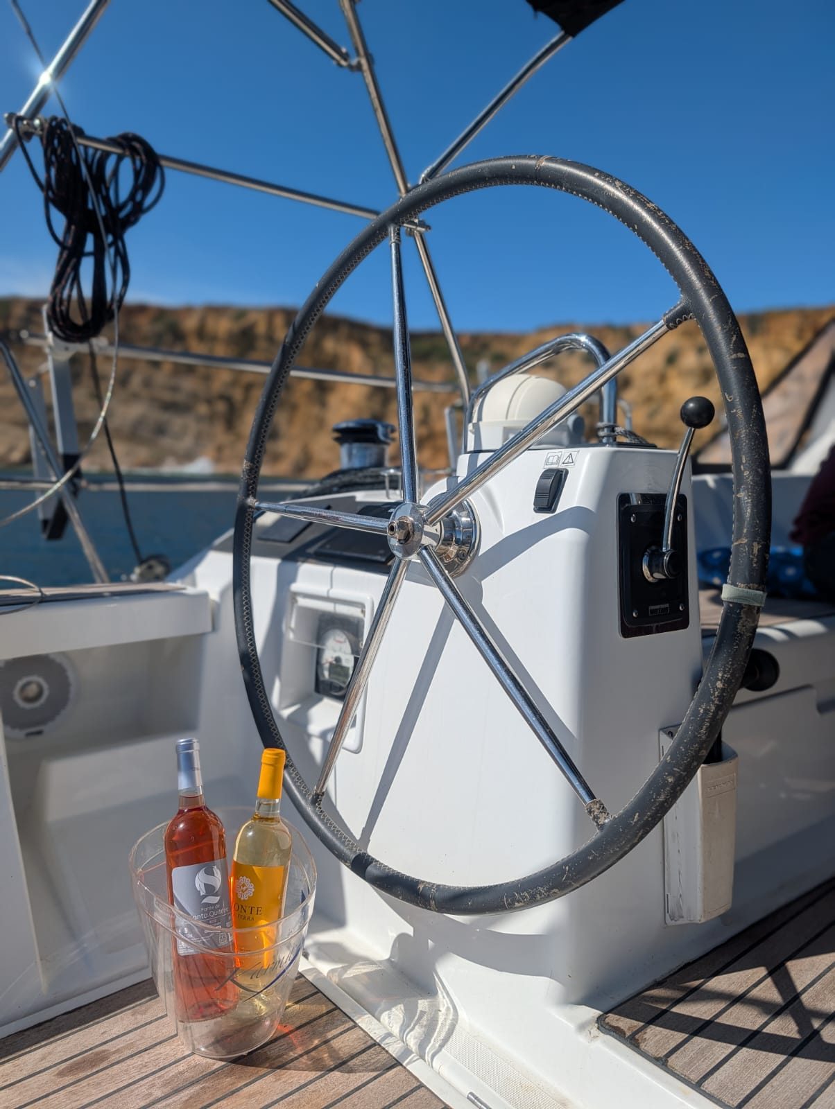Helm and chilled wine on deck